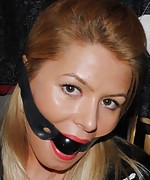 Whore wife poses in latex, cuffs and ball-gag